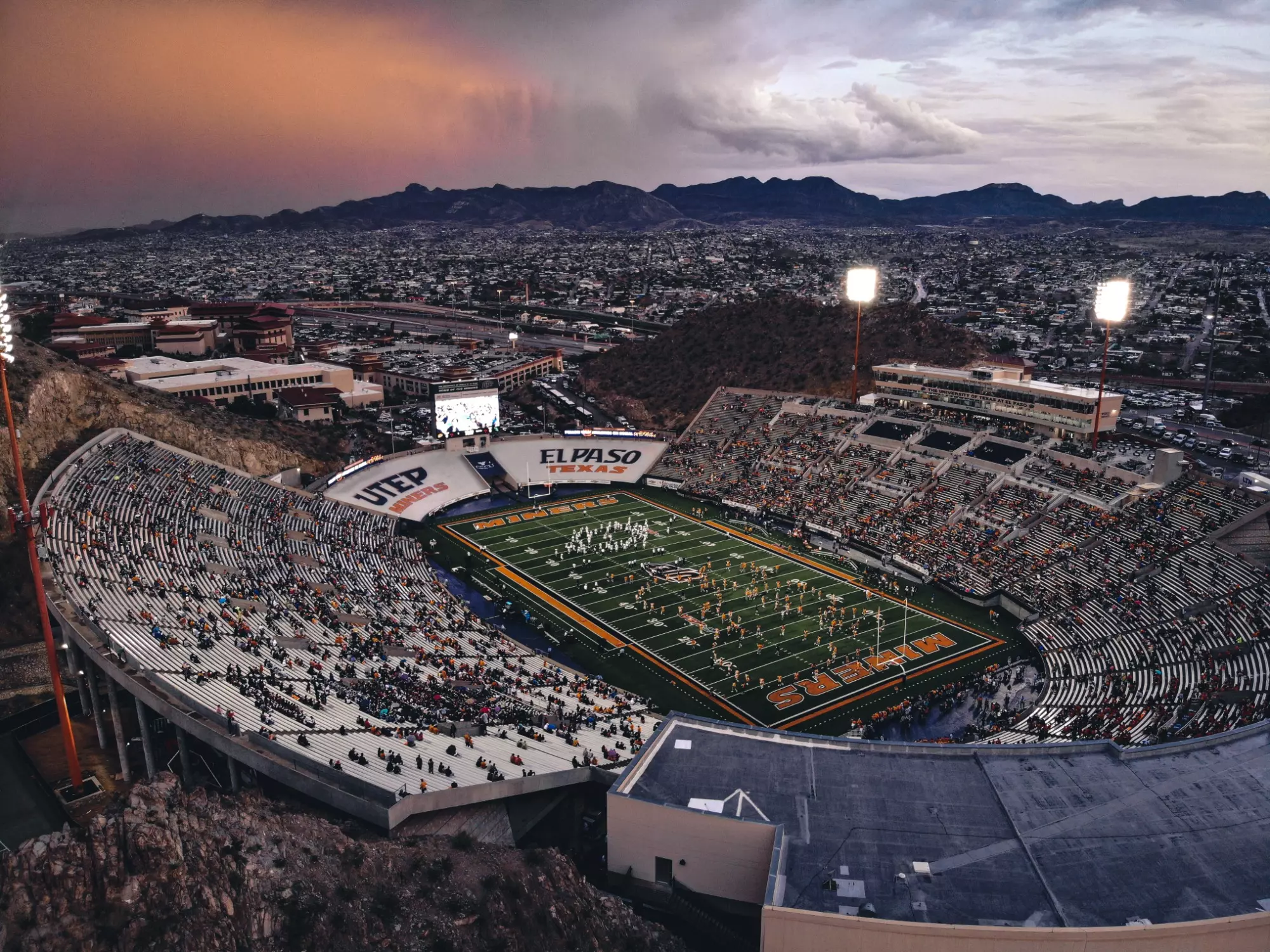 UTEP Sun Bowl stadium at sunset with Franklin Mountains in the background