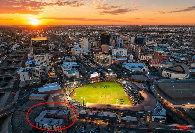 Aerial view of downtown El Paso and Southwest University Park near Palm Court Apartments at sunset